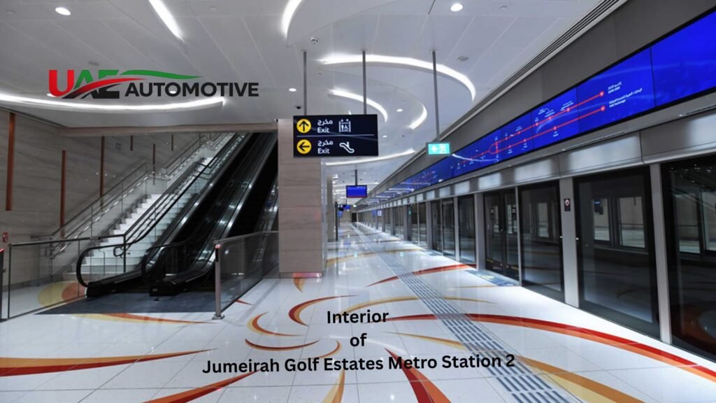 Interior of Jumeirah Golf Estates Metro Station 2 in Dubai featuring a spacious metro platform with platform screen doors, escalators, illuminated ceiling, directional signage, and modern architectural design.
