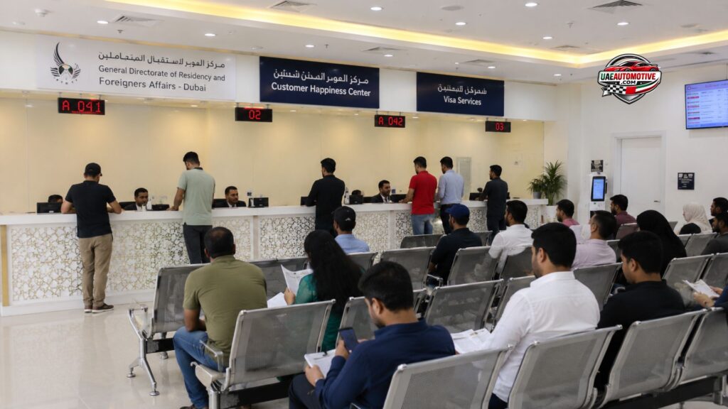 Visitors waiting at the Al Aweer Immigration Office reception area in Dubai while immigration officers assist applicants at service counters and visa processing desks.