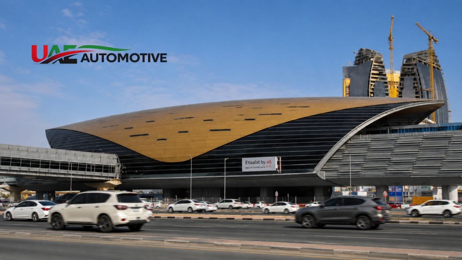 Etisalat Metro Station (Now “E&”): The Complete Verified Guide (2026) Realistic exterior view of Etisalat Metro Station (now E&) in Dubai with its iconic gold roof and vehicles passing on the road.