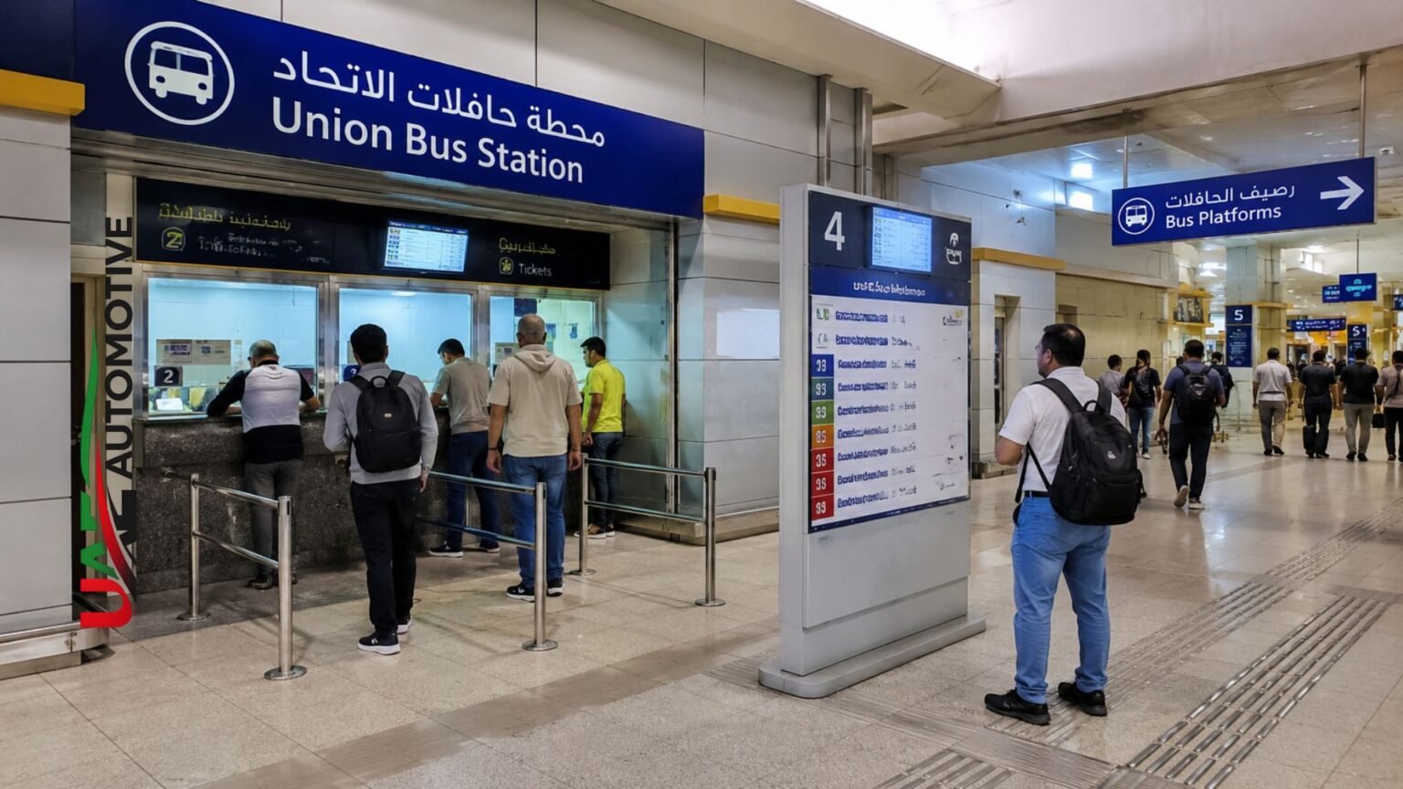 Union Bus Station Ticket Counter, Dubai: What You Can Actually Buy There (2026 Guide) People standing at the Union Bus Station ticket counter in Dubai with route information boards and bus platform signs inside the terminal.