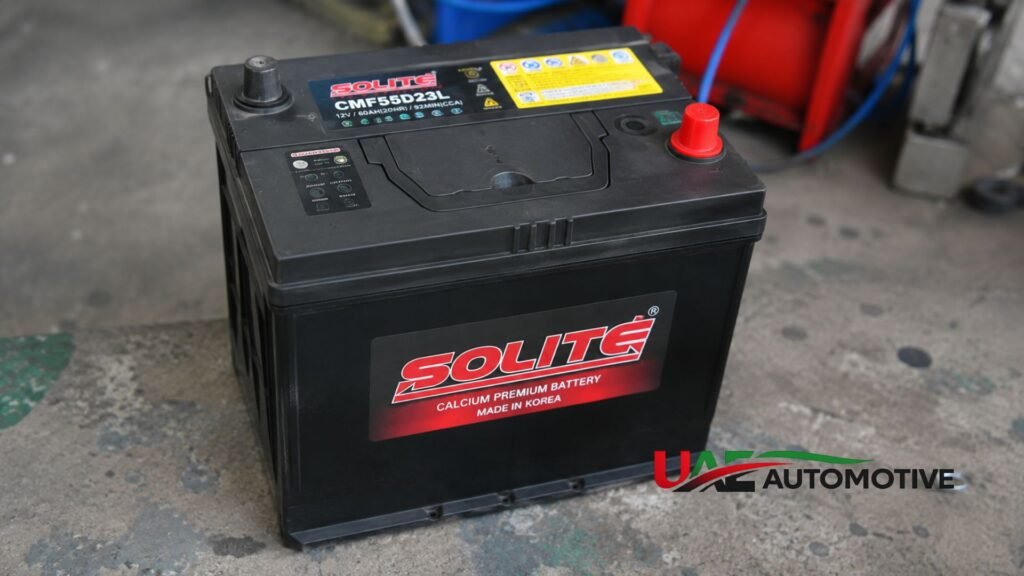 Solite maintenance-free car battery placed on a workshop floor before installation in a vehicle.